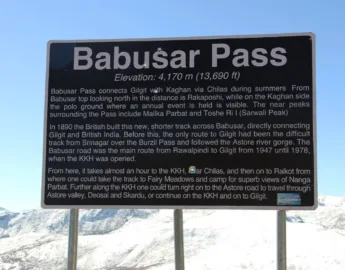 billboard at babusar top displaying all the details of babusar top that is 13700ft above sea level