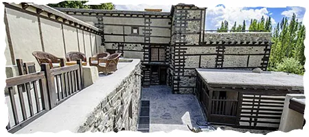 The historic Shigar Fort palace on the rock showing traditional stone architecture and wooden beams in Shigar Valley Skardu