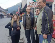 Foreign family tourist group standing near Hotel Demanchi in Naran Valley during a guided trip