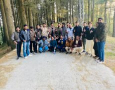 Group of tourists standing on a scenic jungle road at Patriata Top in New Murree during a guided trip with Pakistan Tour & Travel