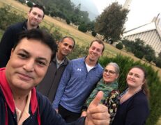 Tour Guide Foreign Family Faisal Mosque Islamabad Murree Tour our guide taking a selfie with a foreign family at Faisal Mosque in Islamabad during an Islamabad and Murree combo tour package by Pakistan Tour & Travel