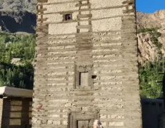 Altit Fort Watchtower Karimabad Hunza Female tourist looking at the ancient wooden Altit Fort watchtower in Karimabad Hunza