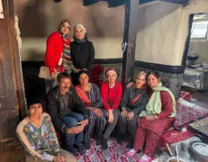 Traditional Burusho Cultural Experience in Gulmit Guests experiencing traditional Burusho hospitality inside a historic wooden home in Gulmit