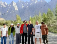 Parents and children taking a souvenir photo along the quiet mountain highway stretch