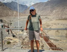 Foreign Tourist at Three Mountain Ranges Junction Gilgit Foreign female tourist smiling at the Junction of the Three Mountain Ranges in Gilgit Pakistan