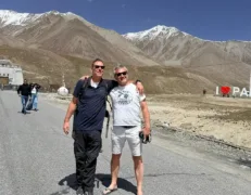 Male Tourists at Pak China Border Gate Two foreign male tourists standing shoulder-to-shoulder with the Khunjerab border gate and I Love Pakistan landmark