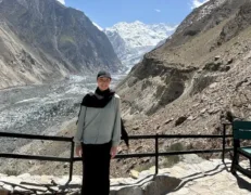 Foreign Tourist at Hopper Glacier Viewpoint Nagar Foreign female tourist standing at the viewpoint boundary overlooking Hopper Glacier in Nagar Valley