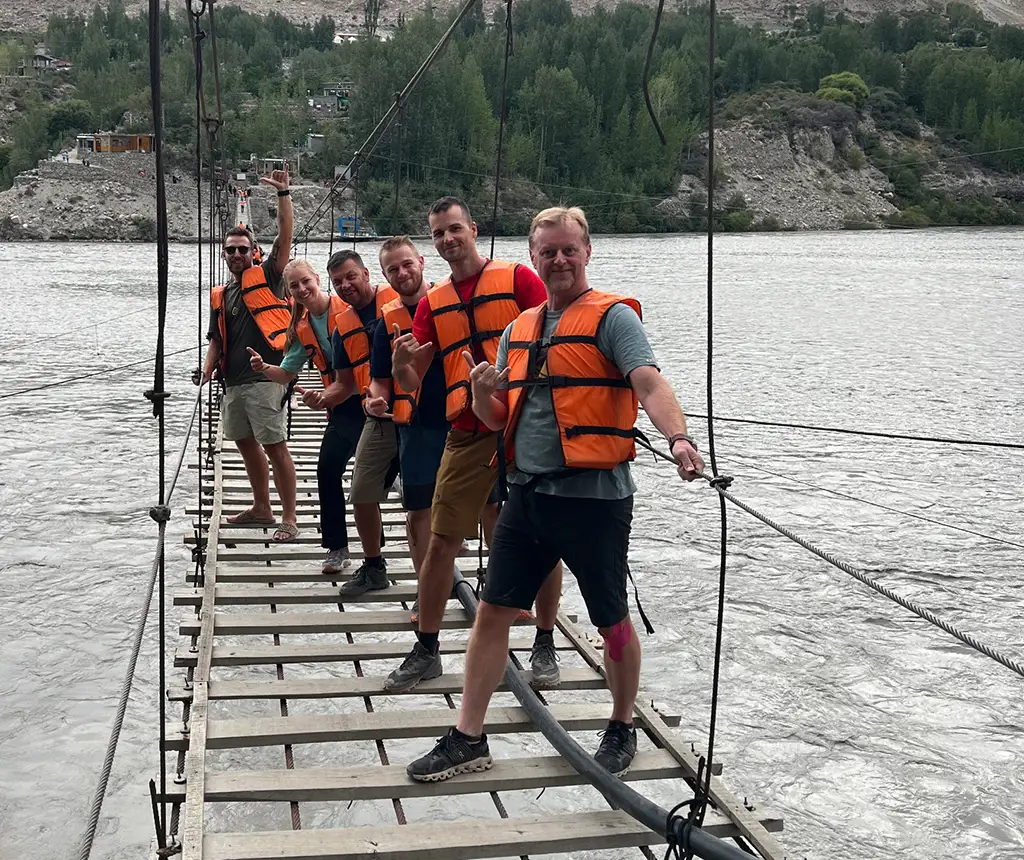 Wooden plank Hussaini Suspension Bridge crossing Hunza River