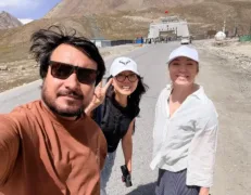 Khunjerab Pass Pak-China Border Monument Tourists taking a selfie in front of the monumental Khunjerab Pass border archway