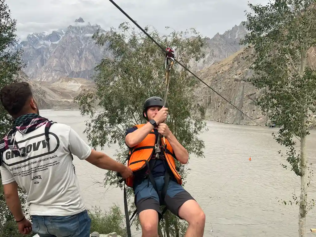 Hussaini Suspension Bridge with Passu Cones peaks background in Gojal Upper Hunza