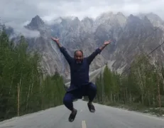 Passu Highway Action Photo Traveler capturing an action jump photo on the quiet highway near Passu
