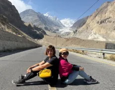 Passu Glacier Mountain Road Viewpoint Travelers sitting on the roadside with clear views of the Passu Glacier tongue