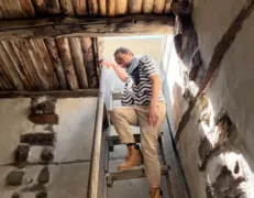 Tourist Descending Wooden Stairs Inside Altit Fort Female tourist descending wooden stairs inside Altit Fort in Karimabad Hunza
