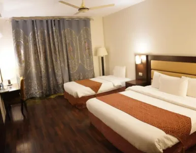 Hunza Darbar Hotel - Deluxe Family Room Deluxe Family Room interior at Hunza Darbar Hotel Karimabad with mountain view beds