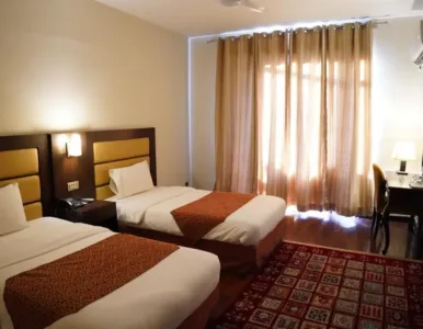 Hunza Darbar Hotel - Deluxe Twin Room Deluxe Twin Room with twin beds and mountain view at Hunza Darbar Hotel
